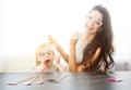 Mother and her daughter with a paper accessories. Royalty Free Stock Photo