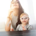 Mother and her daughter with a paper accessories. Royalty Free Stock Photo