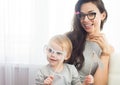 Mother and her daughter with a paper accessories. Royalty Free Stock Photo