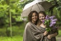 Mother with her daughter in the Park in the rain together under an umbrella. Famely. Royalty Free Stock Photo