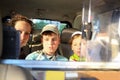 Mother with her daughter and son in backseat