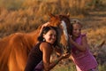 Mother and her daughter with their handsome horse