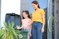Mother and her daughter throwing paper into recycling bin Royalty Free Stock Photo