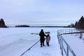 A mother and her daughter walking along the frozen Astotin Lake on a snowy winter day admiring the view at Elk Island Park Royalty Free Stock Photo