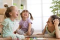 Mother and her daughters playing in board game