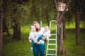 Mother and her daughters with Wooden birdhouse