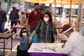 Mother with her girl child wearing mask maintaining social distancing.