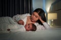 mother with her infant baby on bed at night Royalty Free Stock Photo