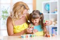 Mother and her kid playing with cubes and learning Royalty Free Stock Photo