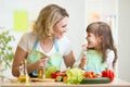 Mother and her kid preparing healthy food and