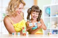 Mother and her kids playing with cubes Royalty Free Stock Photo