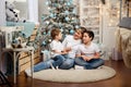 Mother and her kids playing at home on Christmas holiday. Royalty Free Stock Photo