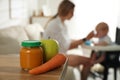 Mother with her little baby at home, focus on healthy puree and ingredients Royalty Free Stock Photo