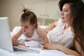 Mother and her little baby at home. Mother with her baby watching something on digital tablet. Royalty Free Stock Photo