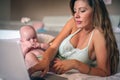 Mother and her little baby at home. Mother working at home. Royalty Free Stock Photo