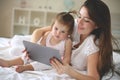 Mother and her little baby at home. Mother with her baby watching something on digital tablet. Royalty Free Stock Photo