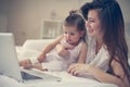 Mother and her little baby at home. Mother with her baby watching something on digital tablet. Royalty Free Stock Photo