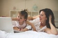 Mother and her little baby at home. Mother with her baby watching something on digital tablet. Royalty Free Stock Photo