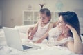 Mother and her little baby at home. Mother with her baby watching something on digital tablet. Royalty Free Stock Photo