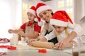 Mother and her cute little children making Christmas cookies in kitchen Royalty Free Stock Photo