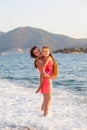 Mother and her little daughter on the beach during sunset Royalty Free Stock Photo