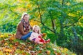 Mother and her little daughter at beautiful autumn park Royalty Free Stock Photo