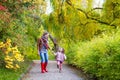 Mother and her little daughter at beautiful autumn park Royalty Free Stock Photo