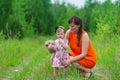 Mother and her little daughter on a green meadow. Royalty Free Stock Photo