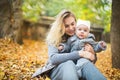 Mother and her little daughter play cuddling on autumn walk in nature outdoors Royalty Free Stock Photo