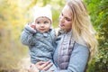 Mother and her little daughter play cuddling on autumn walk in nature outdoors Royalty Free Stock Photo