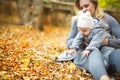 Mother and her little daughter play cuddling on autumn walk in nature outdoors Royalty Free Stock Photo
