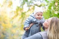 Mother and her little daughter play cuddling on autumn walk in nature outdoors Royalty Free Stock Photo