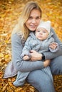 Mother and her little daughter play cuddling on autumn walk in nature outdoors Royalty Free Stock Photo