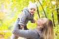 Mother and her little daughter play cuddling on autumn walk in nature outdoors Royalty Free Stock Photo