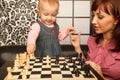 Mother and her little daughter playing chess Royalty Free Stock Photo