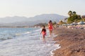 Mother and her little daughter playing and running on the beach Royalty Free Stock Photo