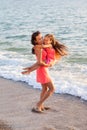 Mother and her little daughter playing and running on the beach Royalty Free Stock Photo