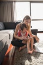 Mother and her little daughter using a tablet on the floor Royalty Free Stock Photo