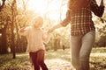 Mother and her little girl holding hands and running trou Royalty Free Stock Photo