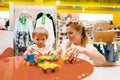 Mother with her little girl playing in kids store Royalty Free Stock Photo