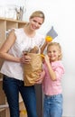 Mother and her Little girl unpacking grocery bag Royalty Free Stock Photo