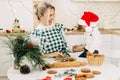 A mother and her little son are preparing Christmas cookies. Happy family in the kitchen. Preparation for the holiday Royalty Free Stock Photo