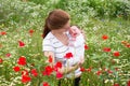 Mother and her newborn baby in a beautiful flower field Royalty Free Stock Photo