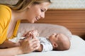 Mother with her newborn baby son lying on bed Royalty Free Stock Photo