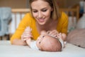 Mother with her newborn baby son lying on bed Royalty Free Stock Photo