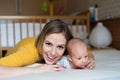 Mother with her newborn baby son lying on bed Royalty Free Stock Photo