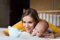 Mother with her newborn baby son lying on bed Royalty Free Stock Photo