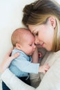 Mother with her newborn baby son lying on bed Royalty Free Stock Photo