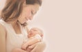 Mother and her Newborn Baby together. Love. Happy Mother and Baby kissing and hugging. Soft image of Beautiful Family. Maternity Royalty Free Stock Photo