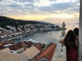 A mother and her older daughter admiring the view from top the bell tower in the town of Korcula during sundown